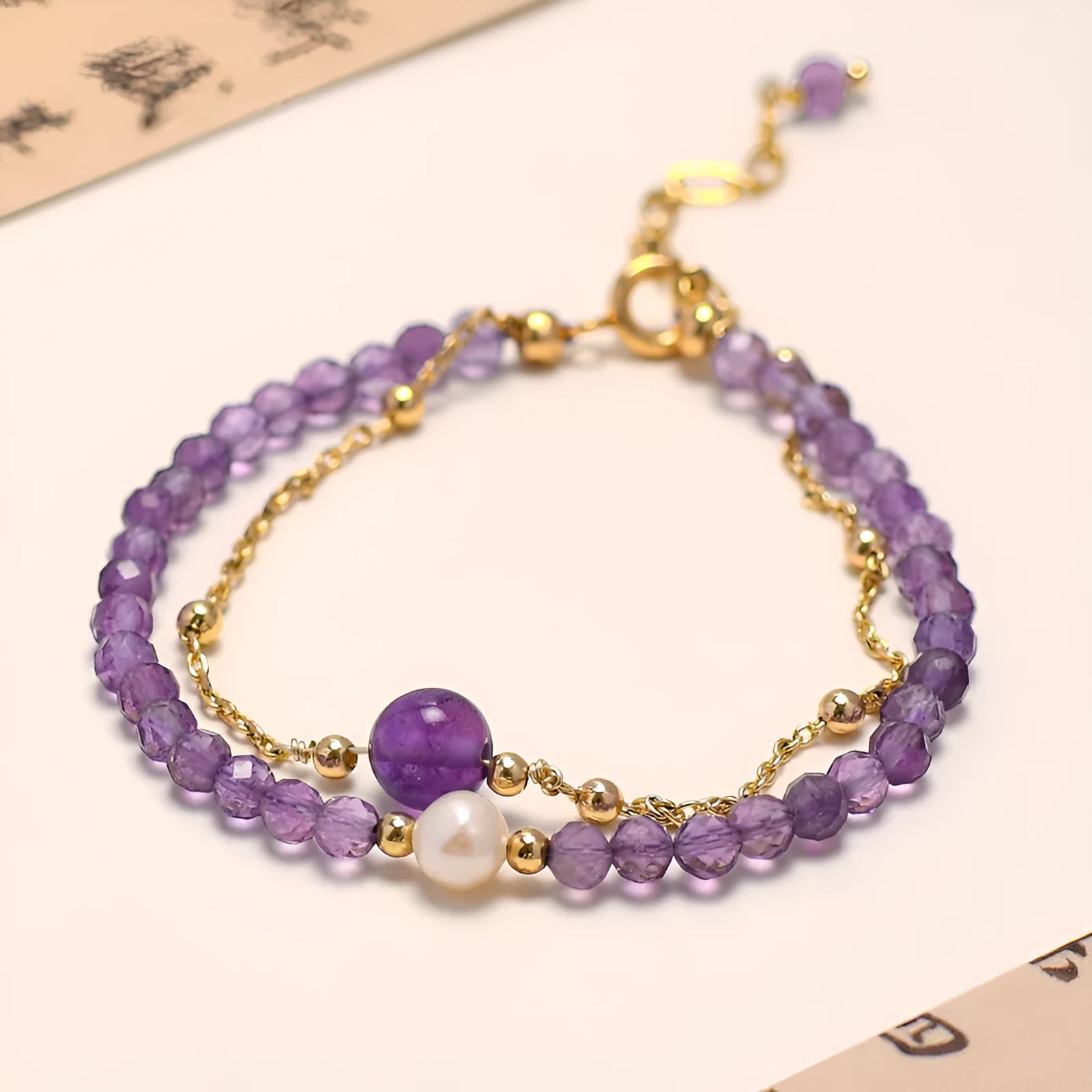 Women's Chinese style crystal bracelet with diamond-shaped pearls and electroplated finish in amethyst colour