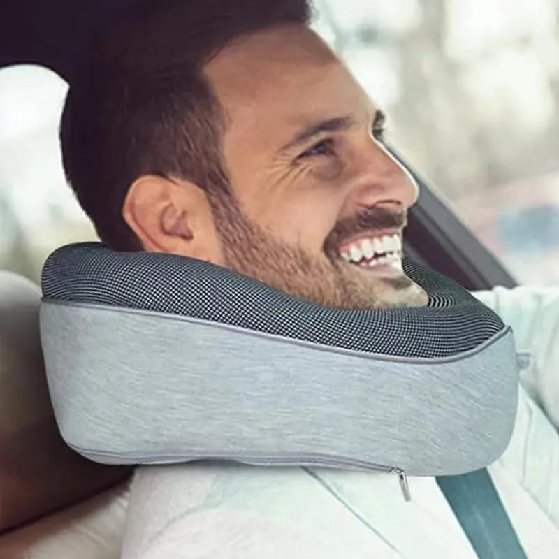 U-shaped memory foam travel neck pillow in navy blue with buckle fastening, shown rolled with carry bag