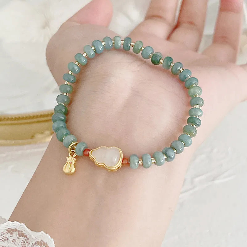 Natural blue water jade bracelet with gourd beads and peace buckle charm on woman's wrist