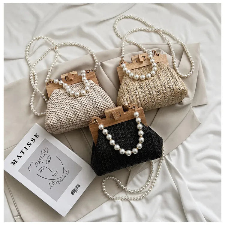 Women's woven straw shoulder bag with pearl chain strap showing interior organisation compartments