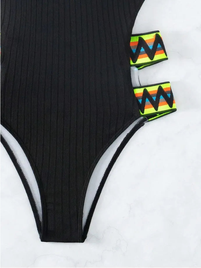 Women's solid colour one-piece swimsuit bikini in black or orange polyester.