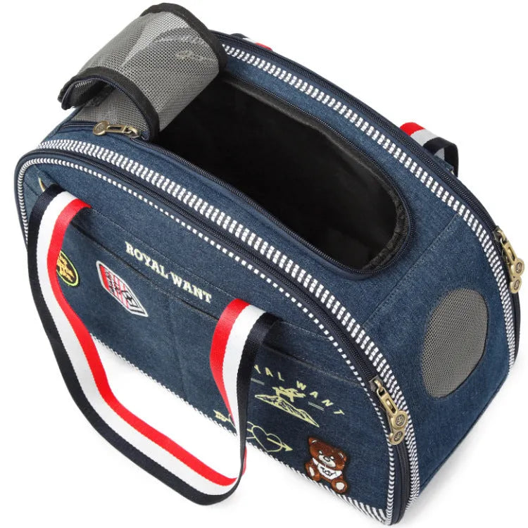Blue denim pet carrier bag with cartoon pattern, measuring 43cm by 20cm by 30cm.
