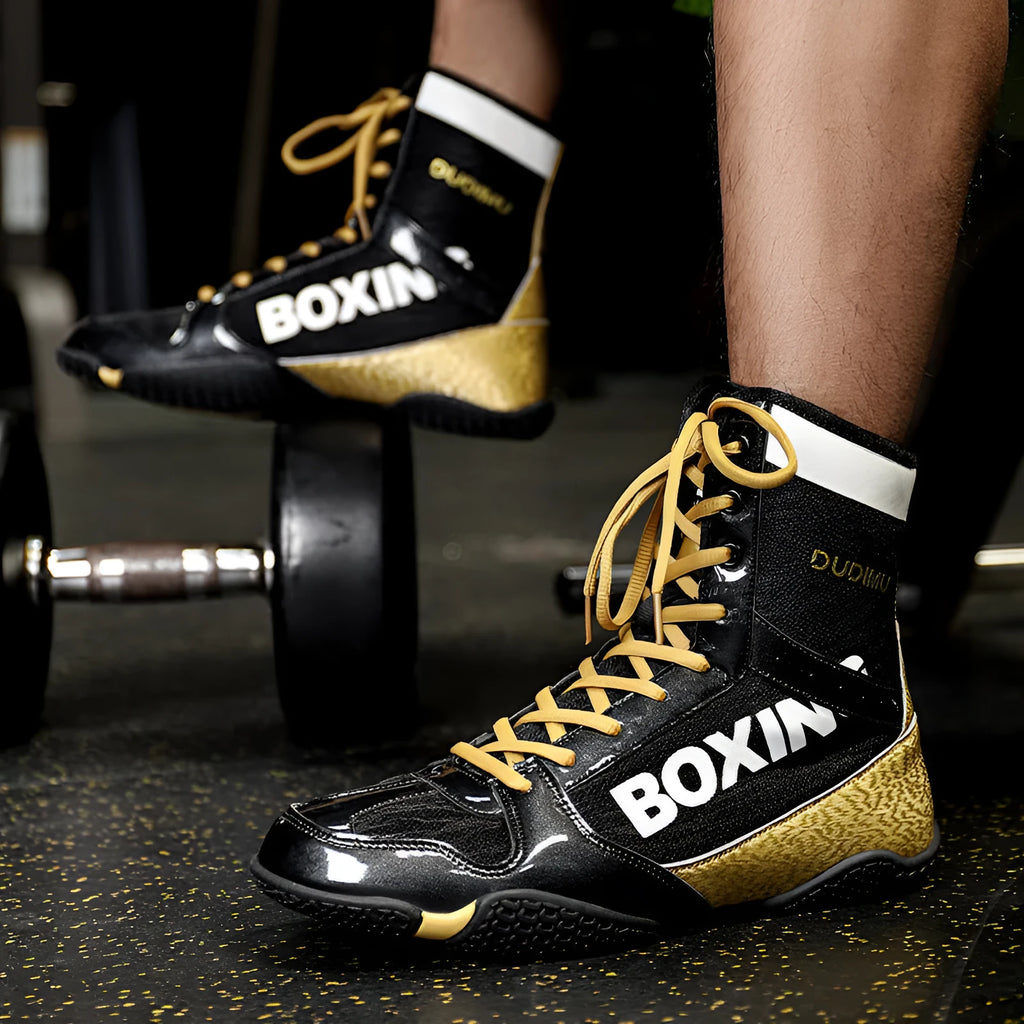 Unisex high-top mixed combat training shoes with mesh and leather upper in black gold colour.