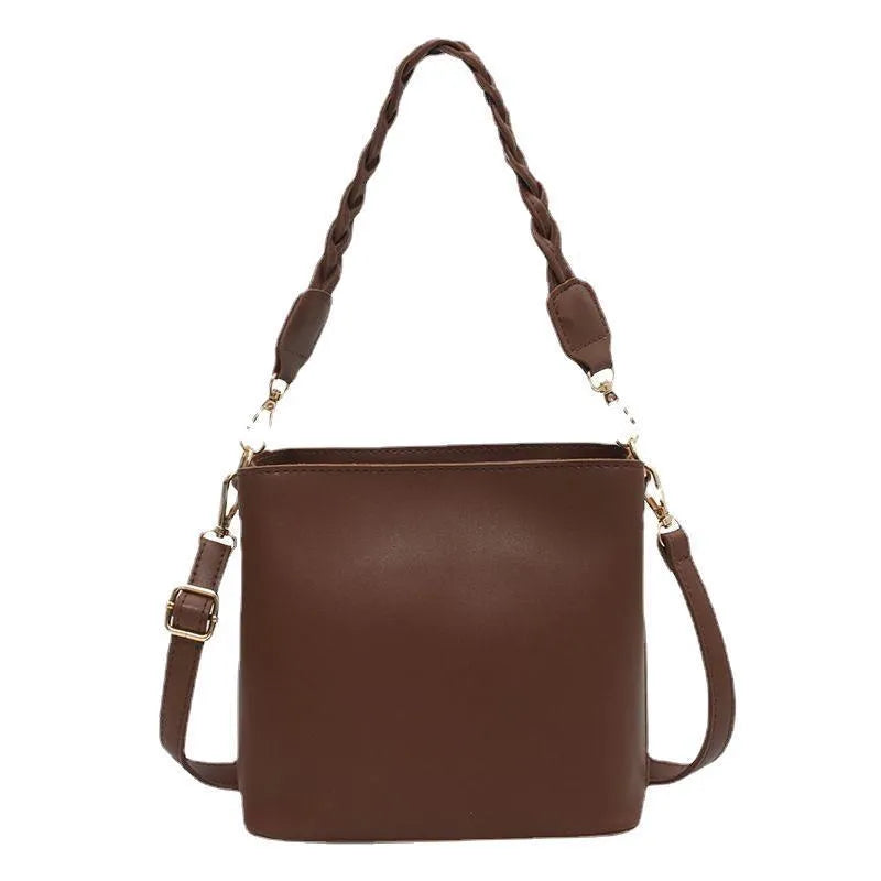 Khaki PU leather bucket bag with woven texture and a crossbody strap.