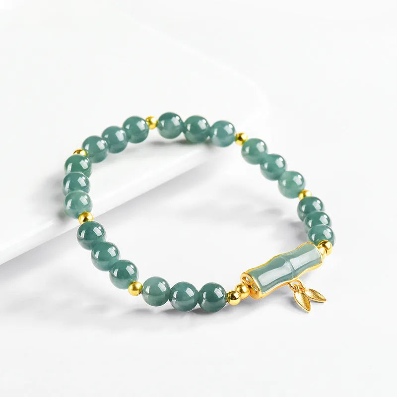 S925 silver bracelet with natural A cargo jade and blue round beads on a wrist.