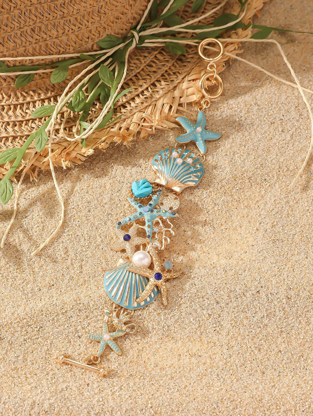 Women's alloy marine bracelet with starfish and anchor detailing in turquoise, red or blue coral colour.