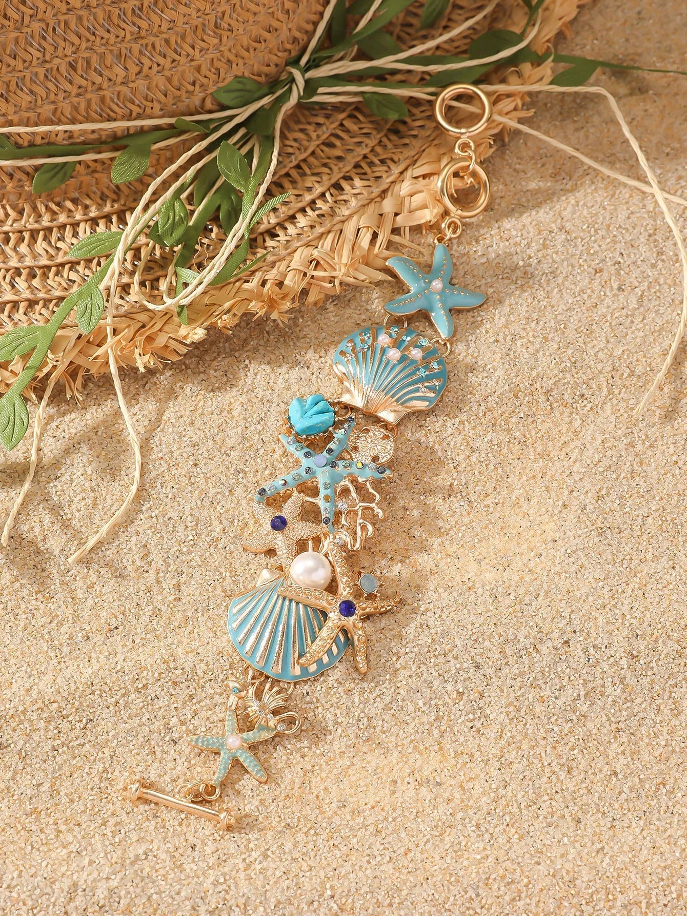Women's alloy marine bracelet with starfish and anchor detailing in turquoise, red or blue coral colour.