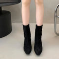 Brown square toe ankle boots with a side zip and a mid kitten heel on a plain background.