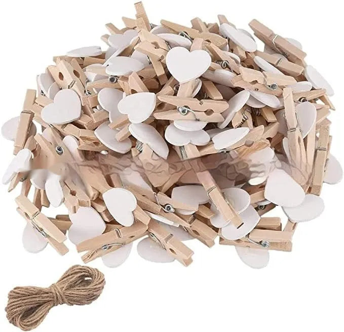 Five handmade solid wood heart-shaped hair clips in red, white, and pink on a wooden surface.