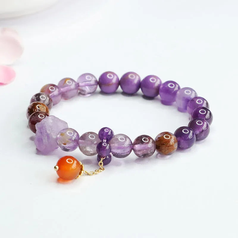 Nine purple fire amethyst and red agate Mori style bracelet with 8mm beads on adjustable cord.