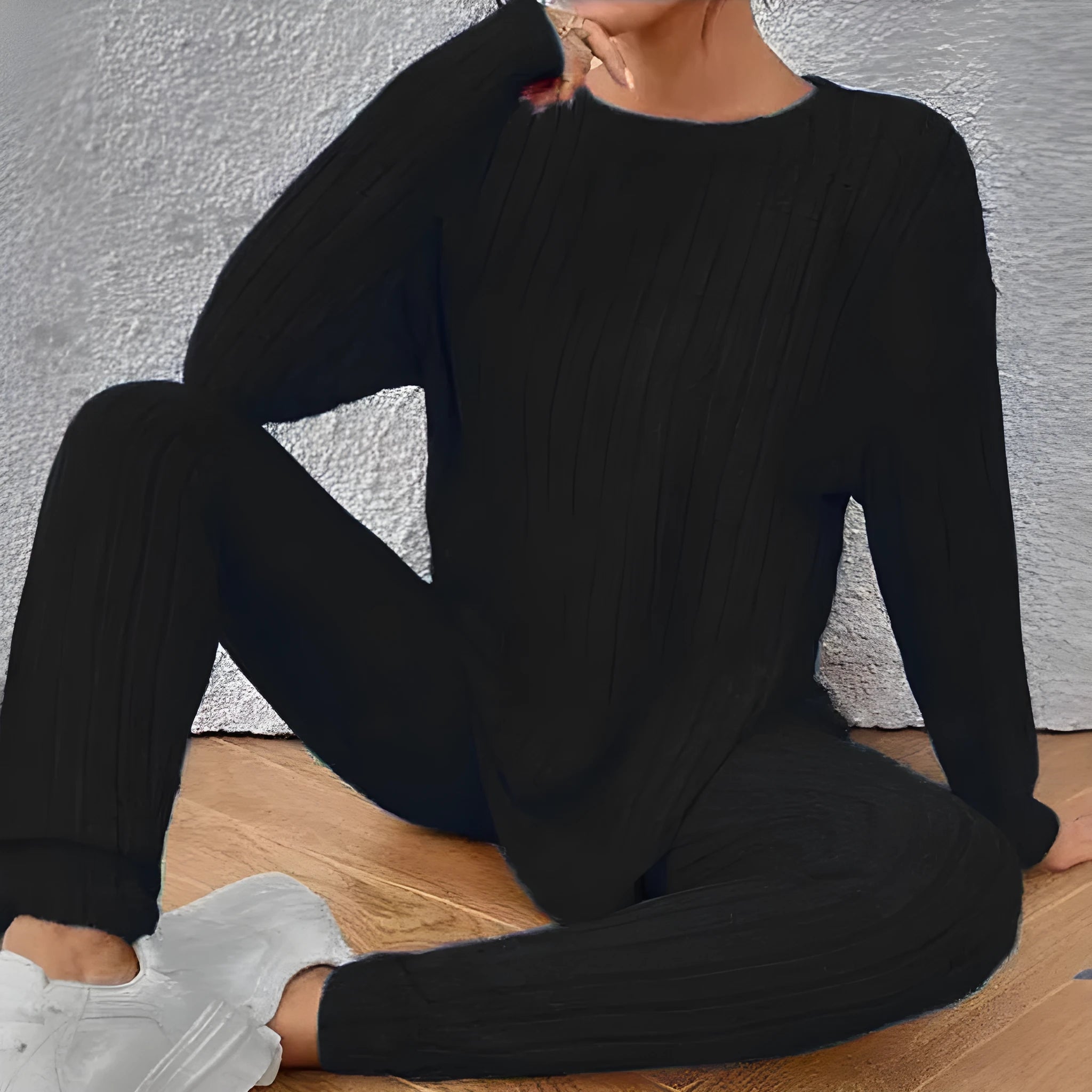 Women's black sunken stripe casual two-piece homewear set with short sleeve top and trousers.