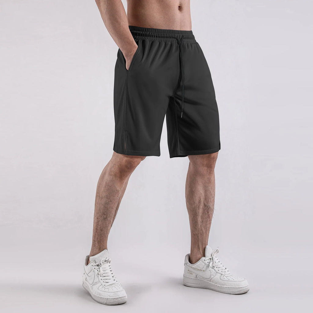Men's black quick-drying mesh fitness shorts with an elastic waistband, shown in a loose, capri-length style.