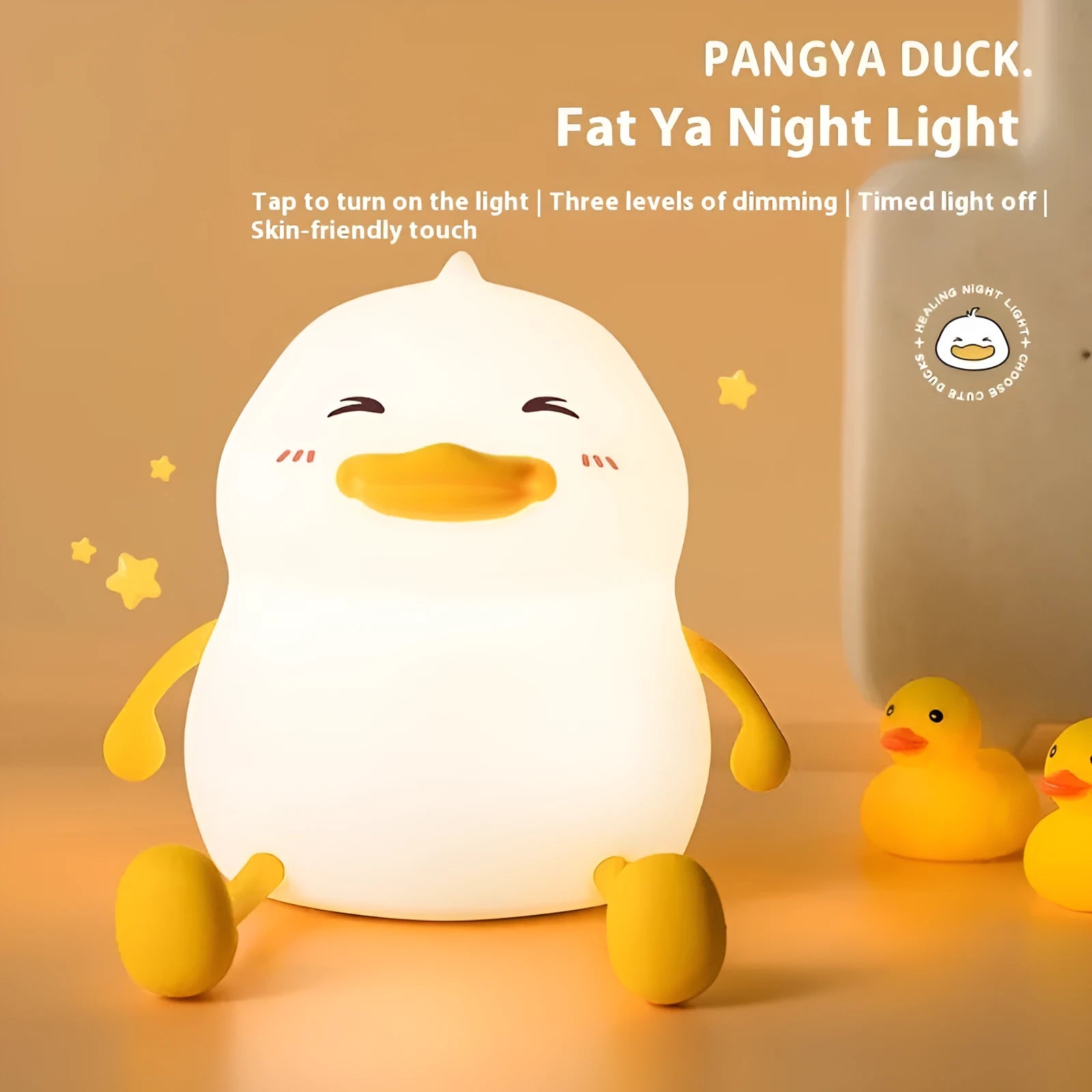 Chubby silicone desk night lamp with integrated mobile phone holder showing soft glowing light.