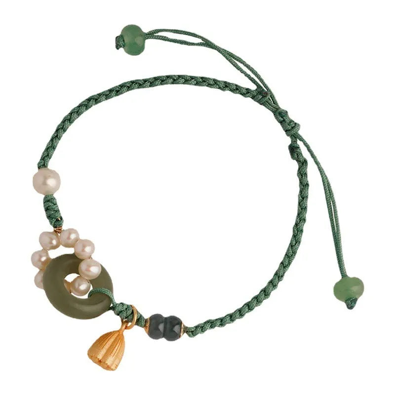 Hand-woven women's watch band with a pearl peace buckle closure on a flexible wire bracelet.