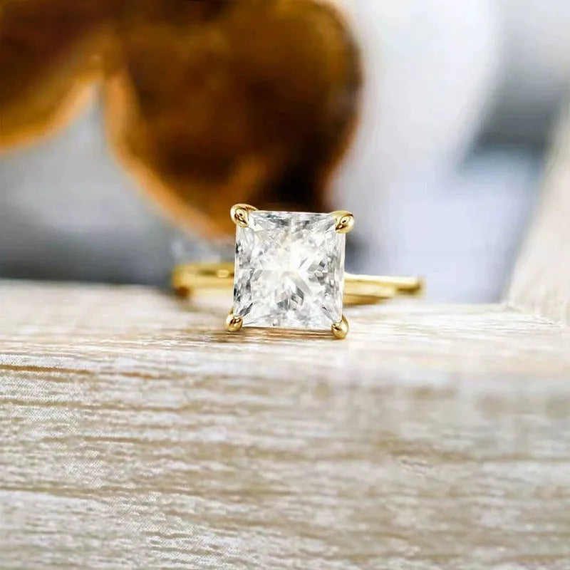 Women's simple geometric 925 sterling silver ring in gold, rose gold, or silver colour on a grey background.