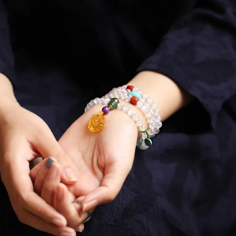 Blue light glass moonstone 108 prayer beads bracelet for women with beeswax finish white colour ethnic style.