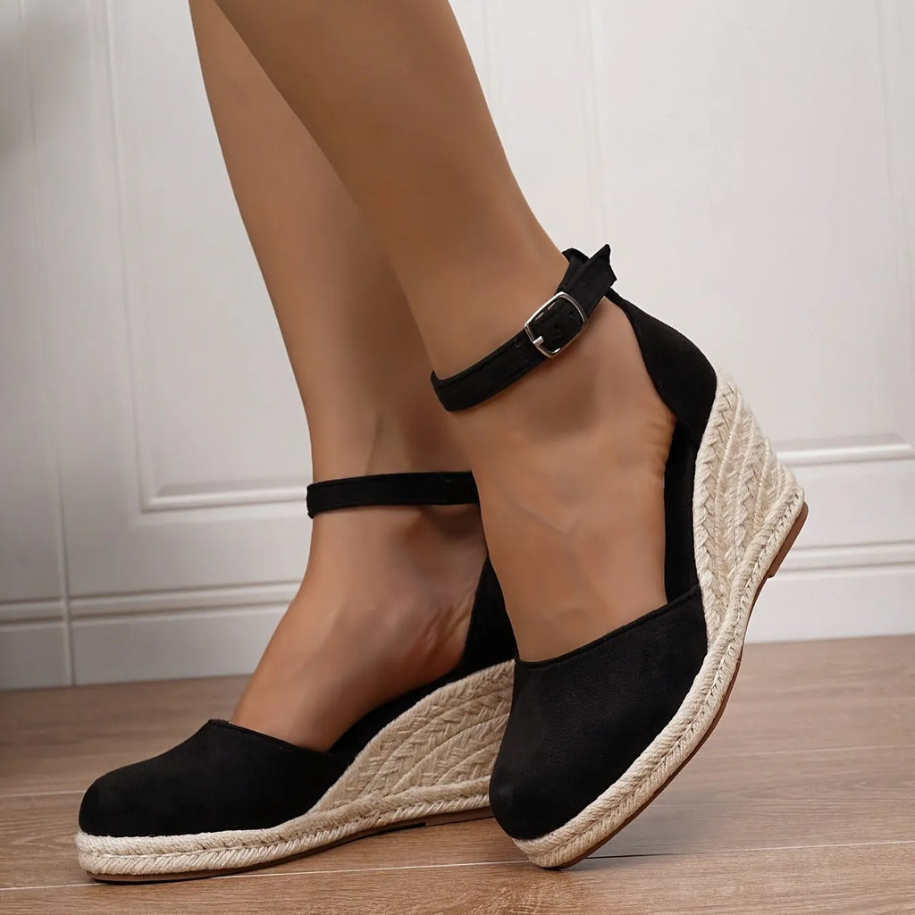 Women's apricot suede wedge sandals with a round toe and buckle strap on a rubber sole.