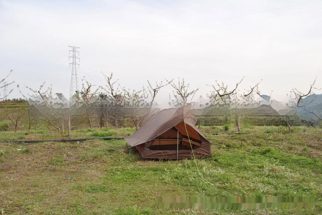 Brown A-line hiking tent erected with hiking poles showing spacious interior for 2-3 people