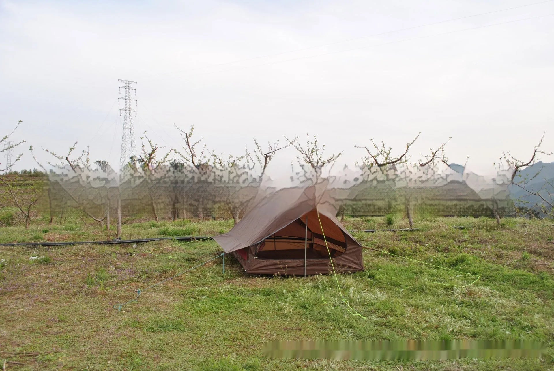 Brown A-line hiking tent erected with hiking poles showing spacious interior for 2-3 people