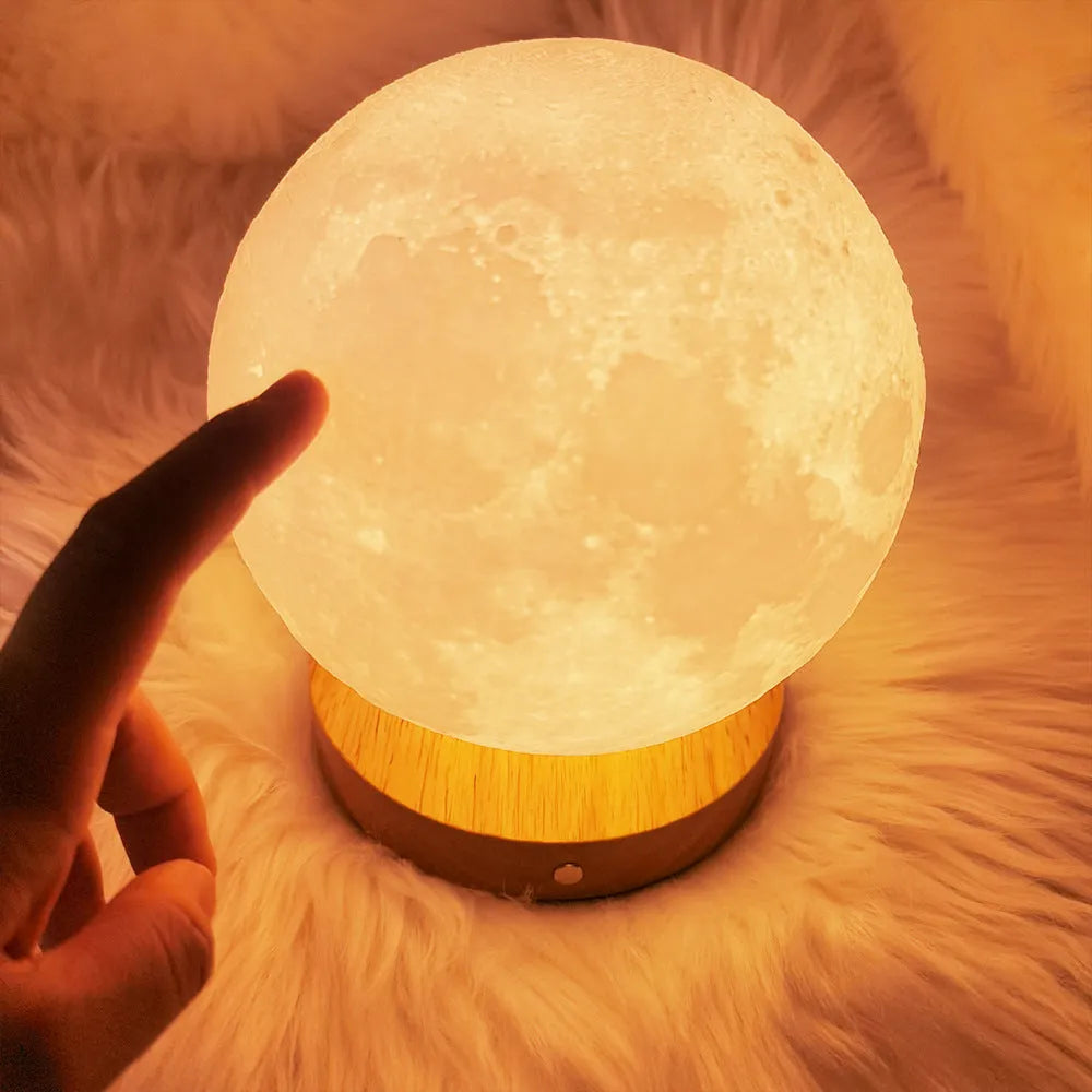 Rotating moon night lamp with wooden base showing wireless control and three colour settings