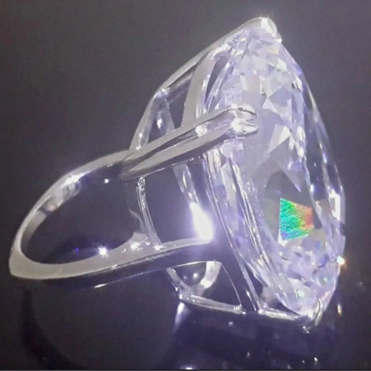Simple white gold-coloured alloy ring with an inlaid square diamond geometric design.