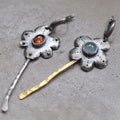 Long retro earrings with two-tone floral geometric design in alloy with electroplated finish.