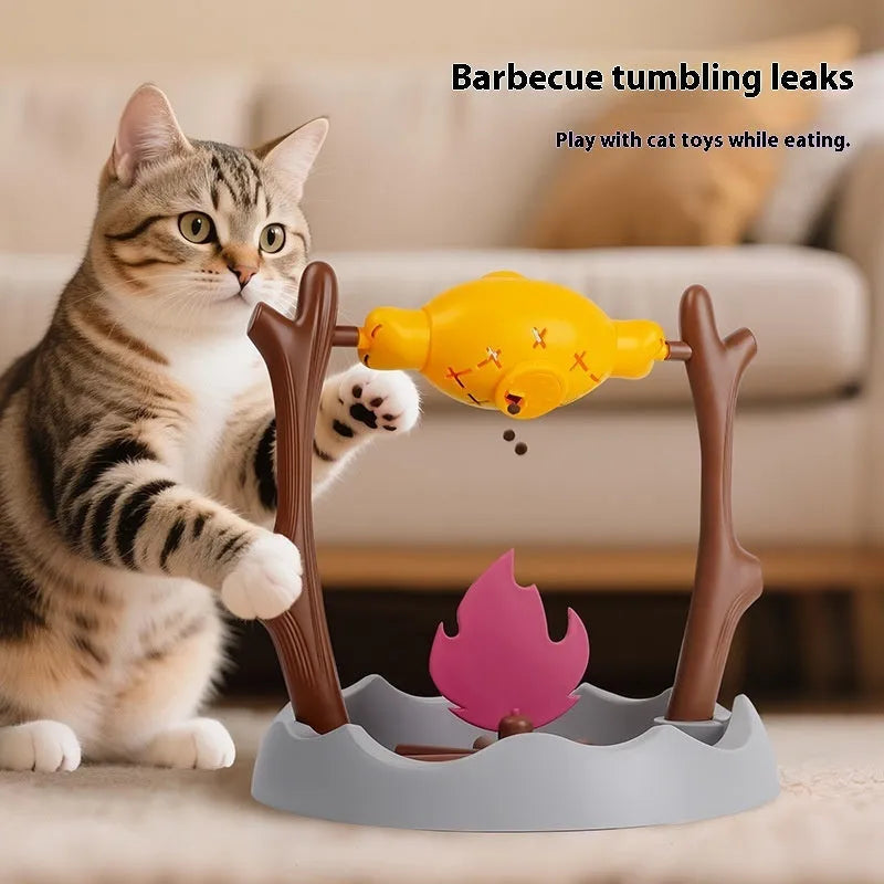Barbecue-style plastic tumbling cat feeder toy for dispensing freeze-dried treats.