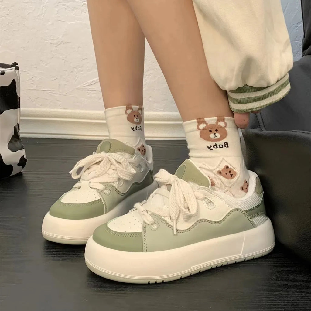 Green women's casual shoes with mesh upper, flat heel, and round toe design