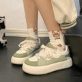 Green women's casual shoes with mesh upper, flat heel, and round toe design