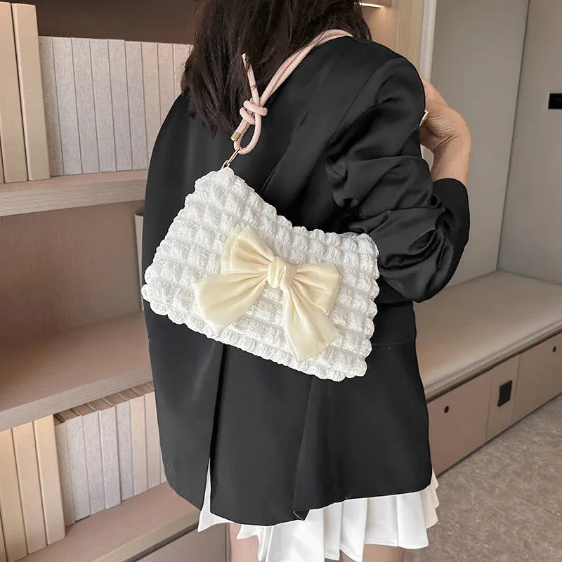 Women's canvas handbag with single shoulder strap in horizontal square shape showing mobile phone compartment
