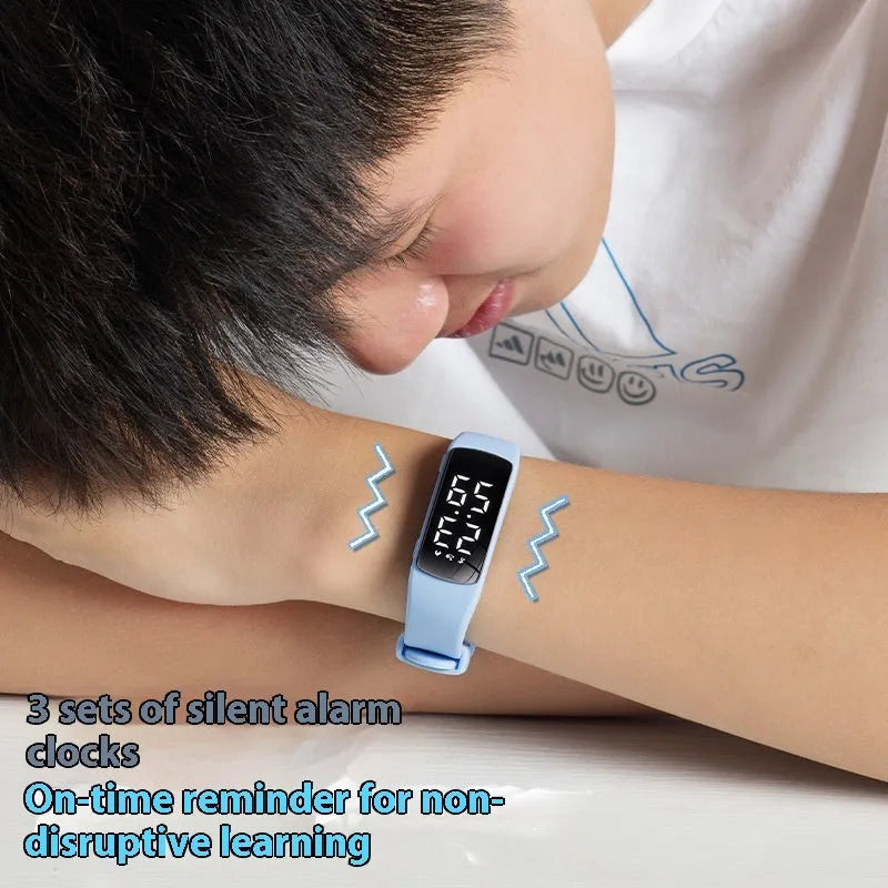 Vibration alarm smart watch with coloured silicone strap and LED display on a wrist.
