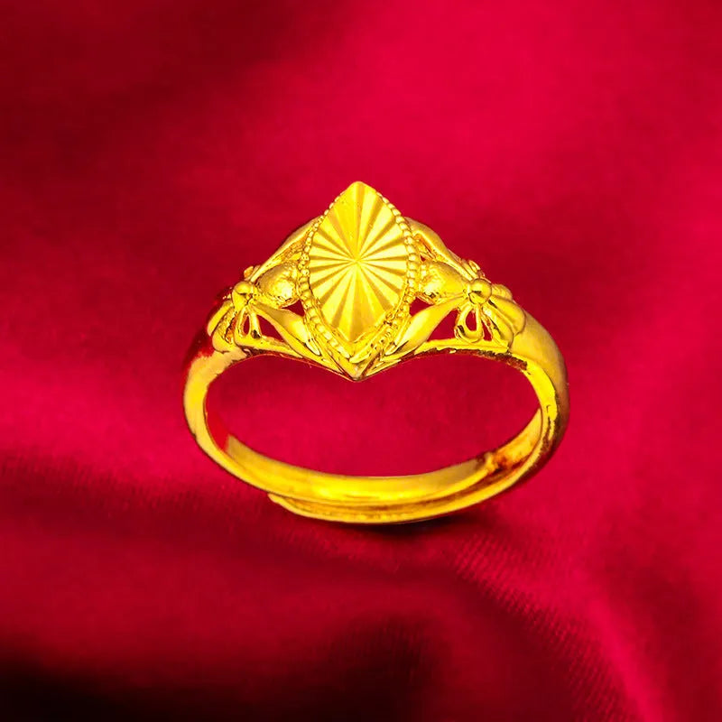 Gold openwork geometric flower ring with a textured alluvial pattern on a brass base.