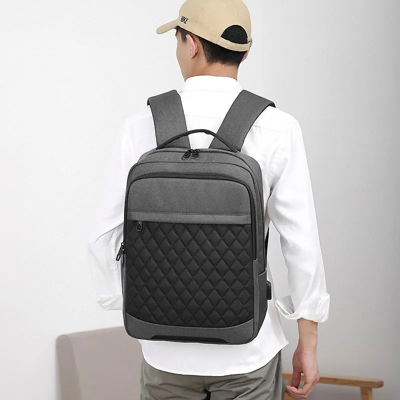 Men's Oxford cloth backpack in black, blue, or grey with curved straps and diamond mesh panels