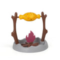 Barbecue-style plastic tumbling cat feeder toy for dispensing freeze-dried treats.