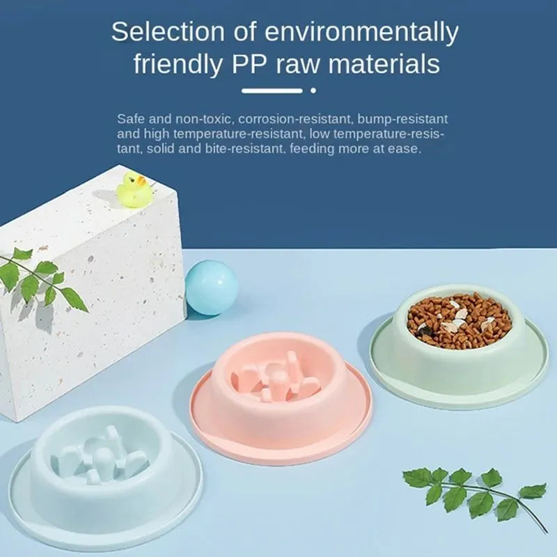 Blue pet slow feeder bowl with maze pattern and non-slip base on a kitchen floor