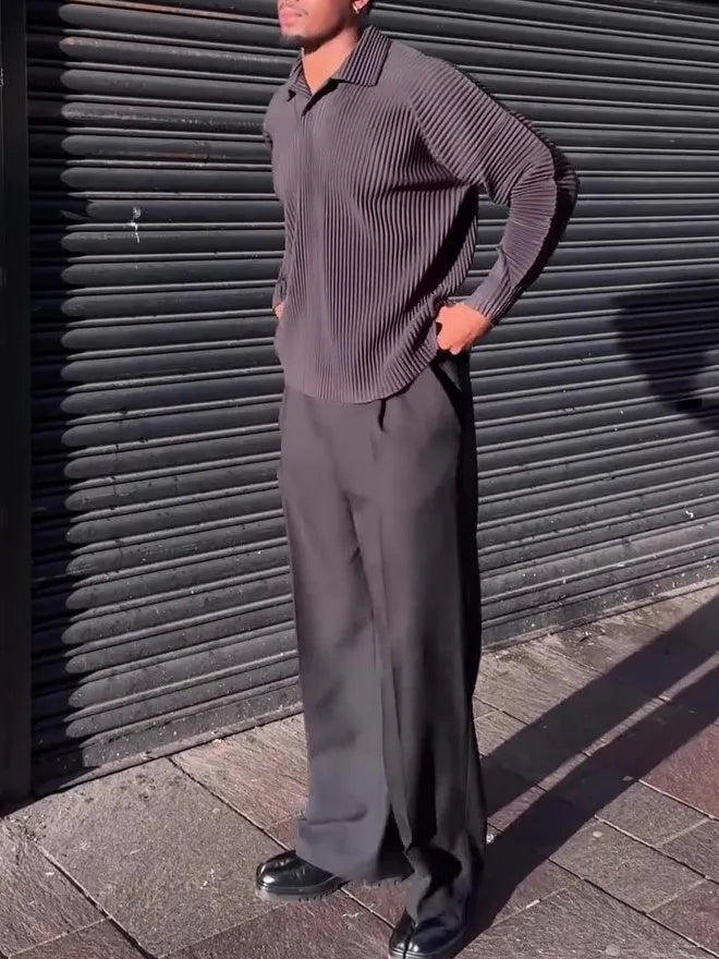 Men's black pleated long-sleeved casual top made from polyester, shown on a model.