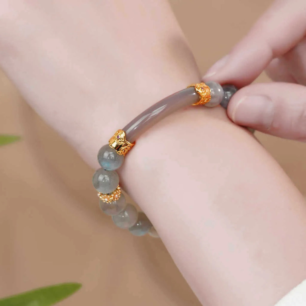 Gray moonstone agate women's half bracelet with 8mm round beads on a wrist.