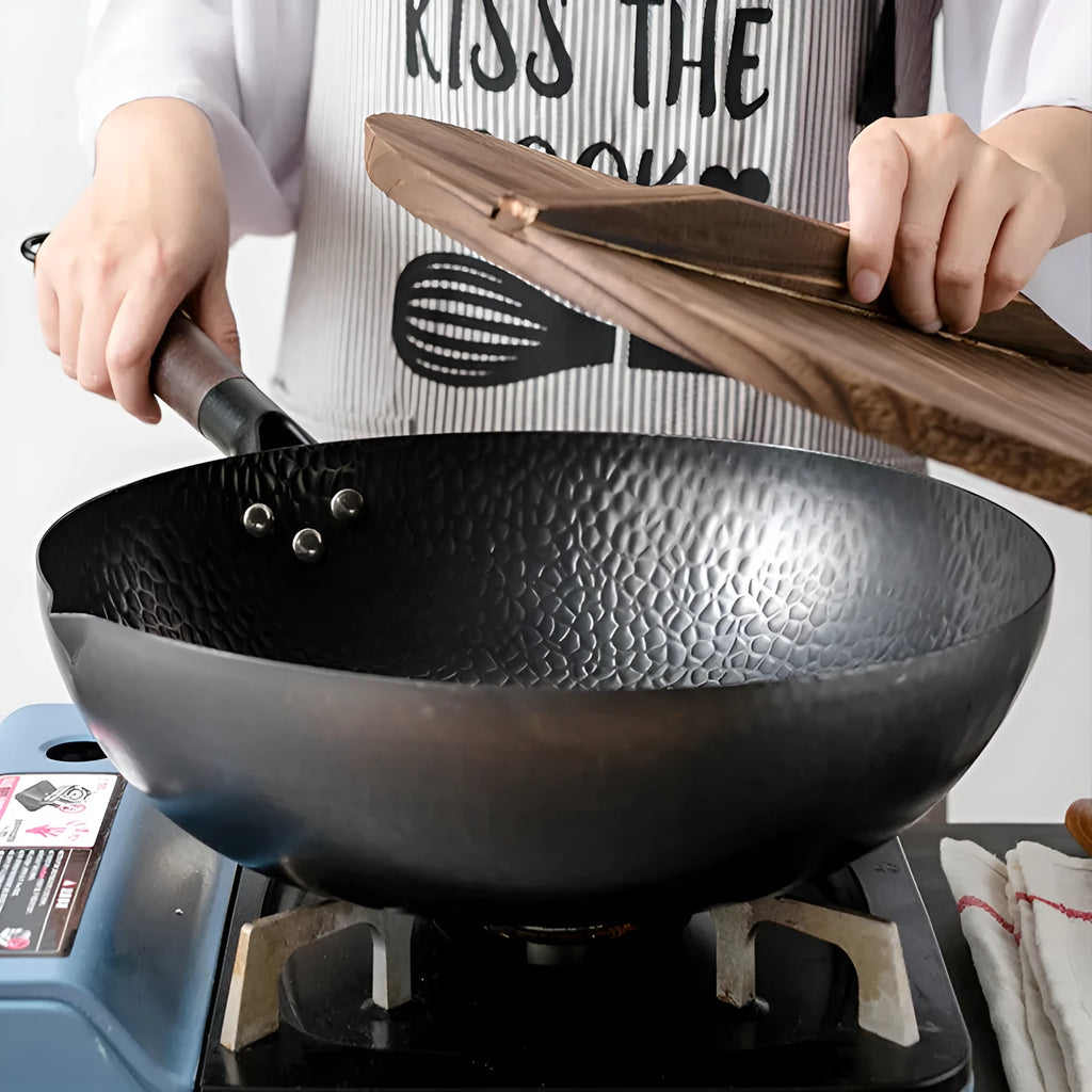 Black traditional iron wok with wooden handle measuring 32cm diameter
