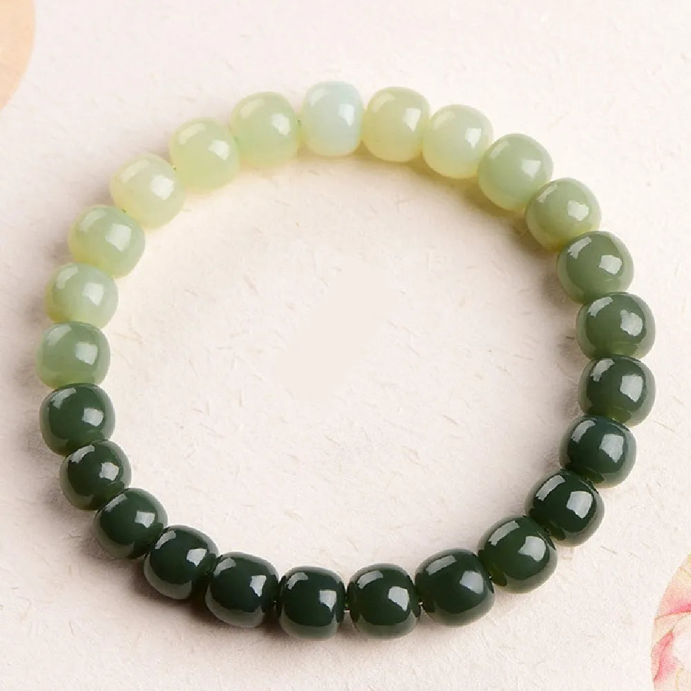 Hetian Jade bracelet with water gradient colours showing polished beads in natural stone