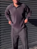 Men's black pleated long-sleeved casual top made from polyester, shown on a model.