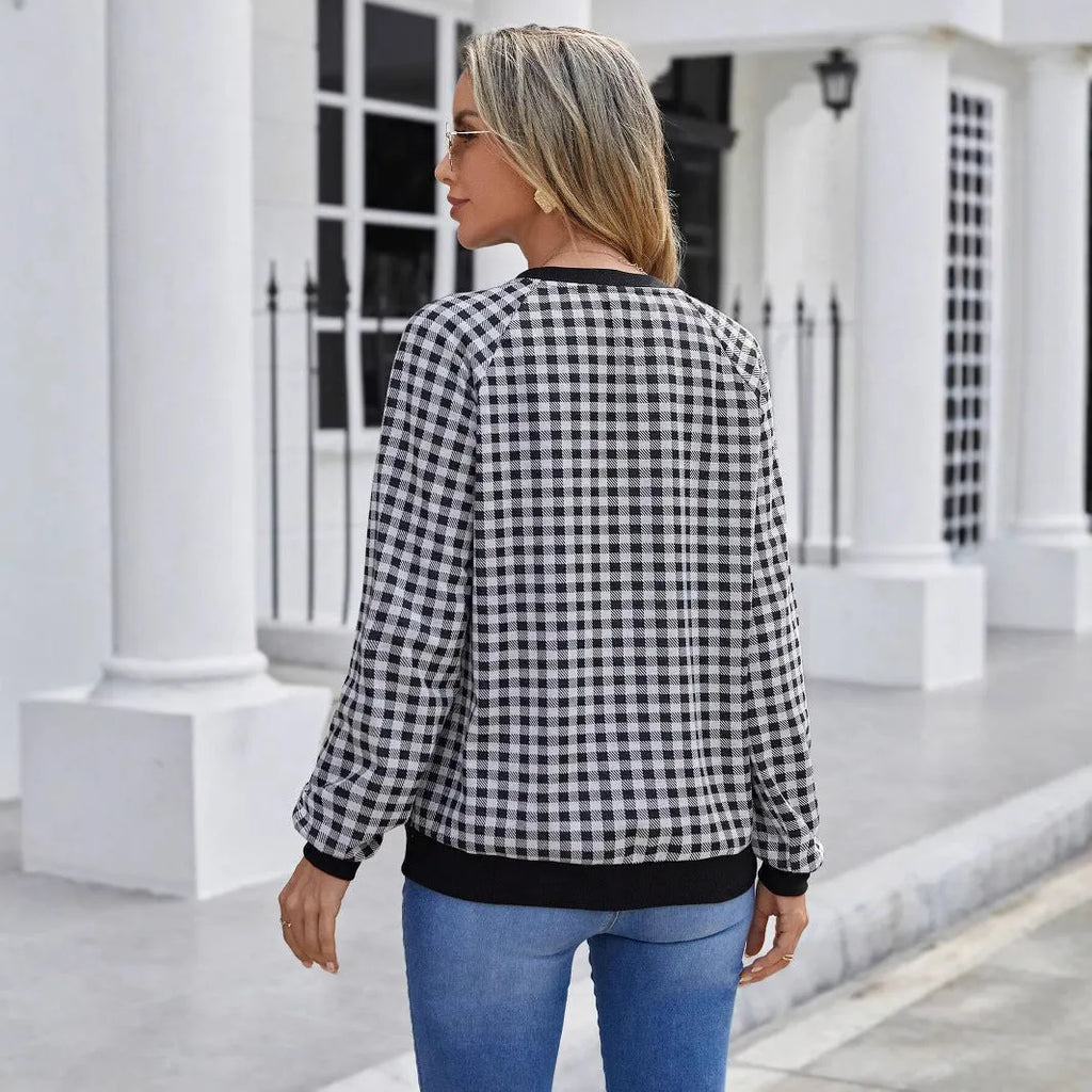 Black long sleeve pullover sweater with a striped plaid pattern, showing regular sleeve cut.