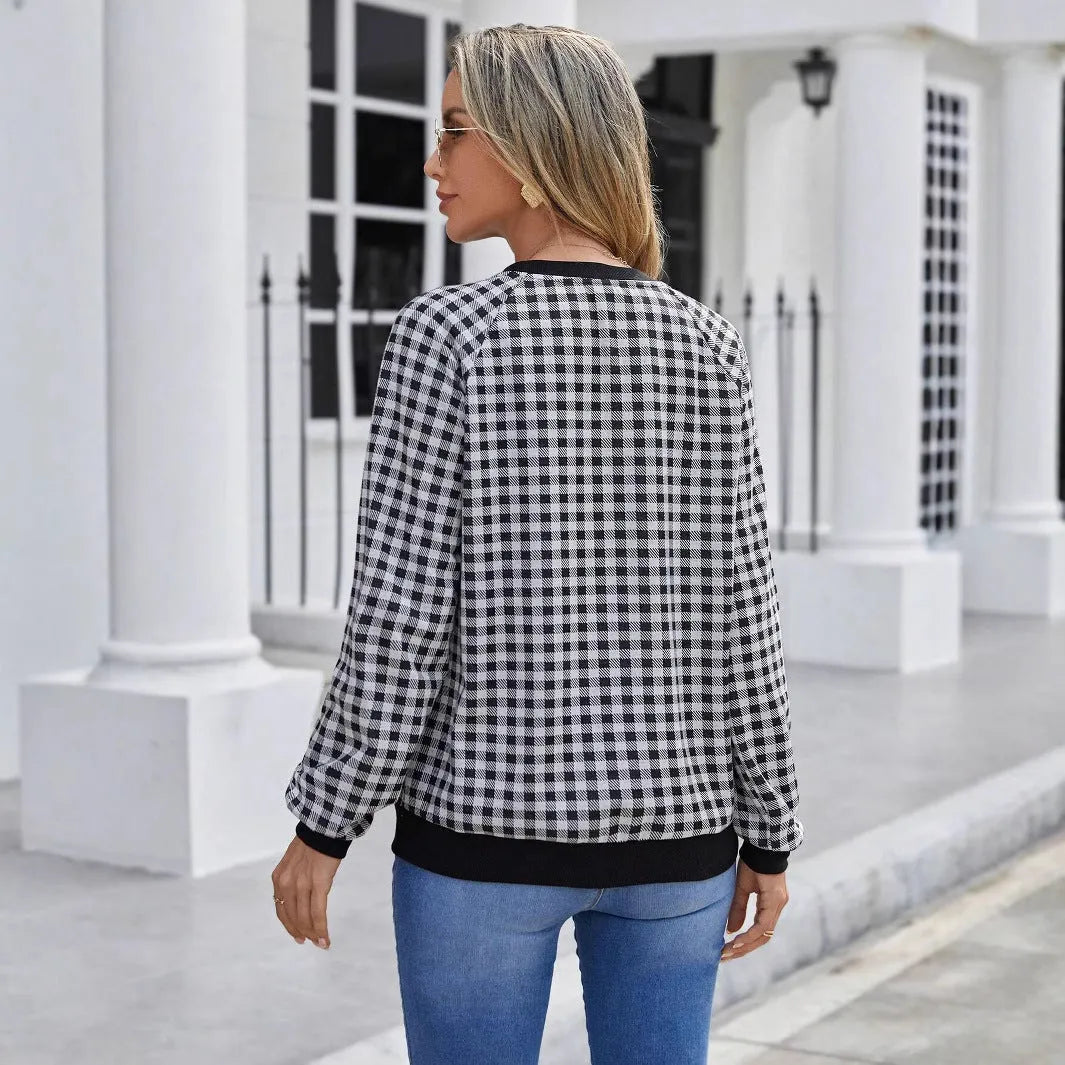Black long sleeve pullover sweater with a striped plaid pattern, showing regular sleeve cut.
