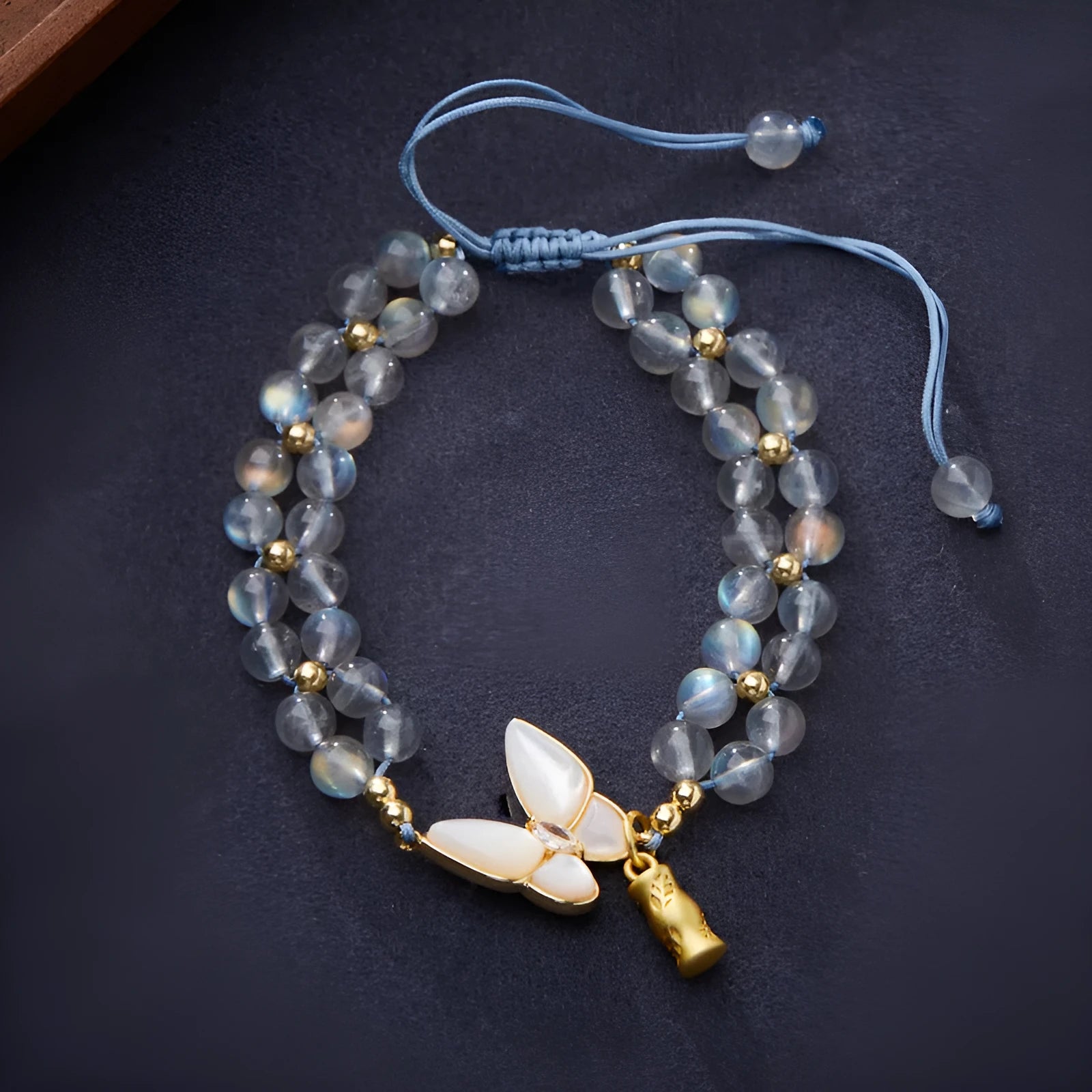 Handmade geometric woven bracelet for women with a grey moonstone and butterfly design.