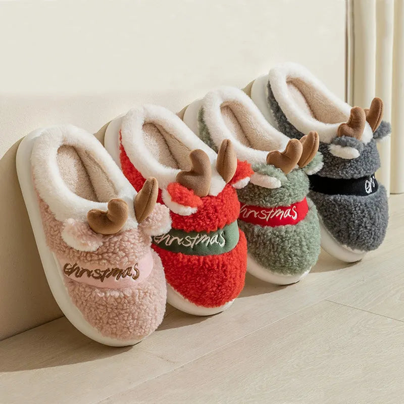 Pair of Christmas elk winter home slippers with suede upper and candy-coloured antler print on bedroom floor