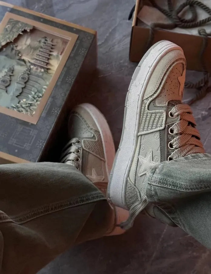 Green low-top casual shoes with star pattern and lace-up closure on a rubber sole.