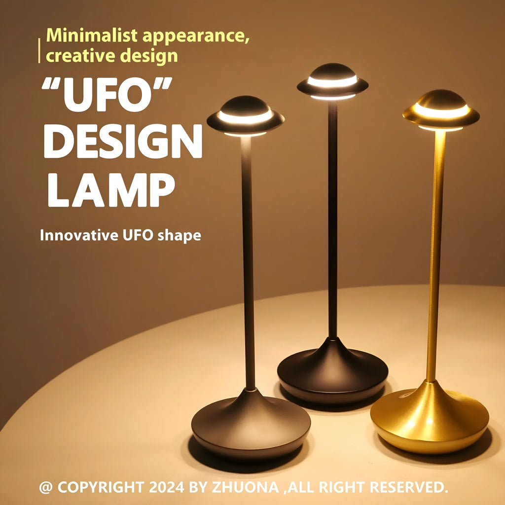 Modern metal UFO-shaped desk lamp in black on a wooden table, showing touch controls.