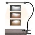 Black and white USB-powered LED desk lamp with a 26 cm long adjustable gooseneck neck on a table.
