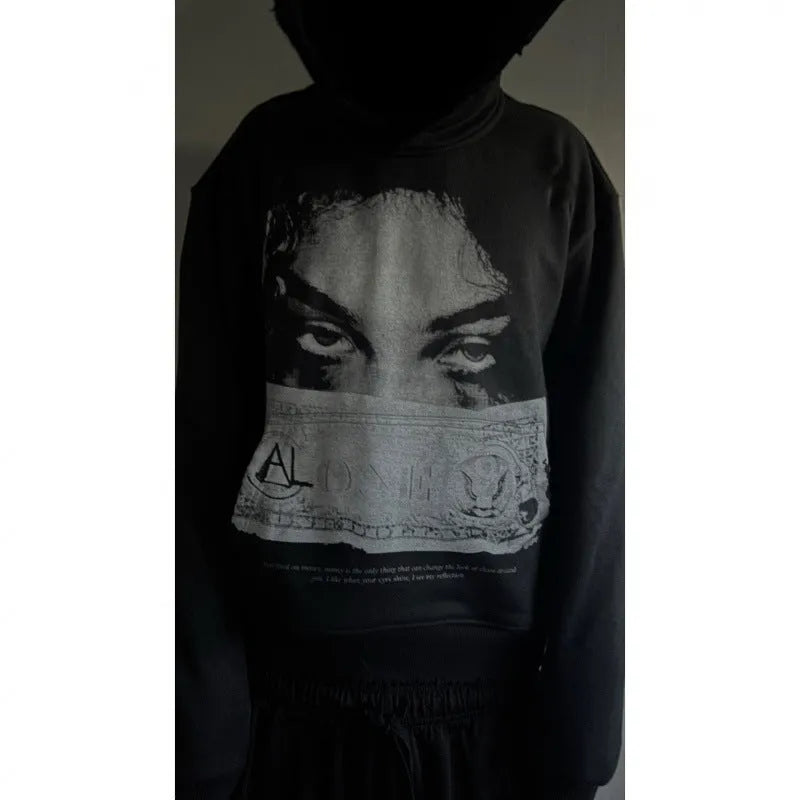 Women's black hoodie with a cartoon pattern print, loose fit.