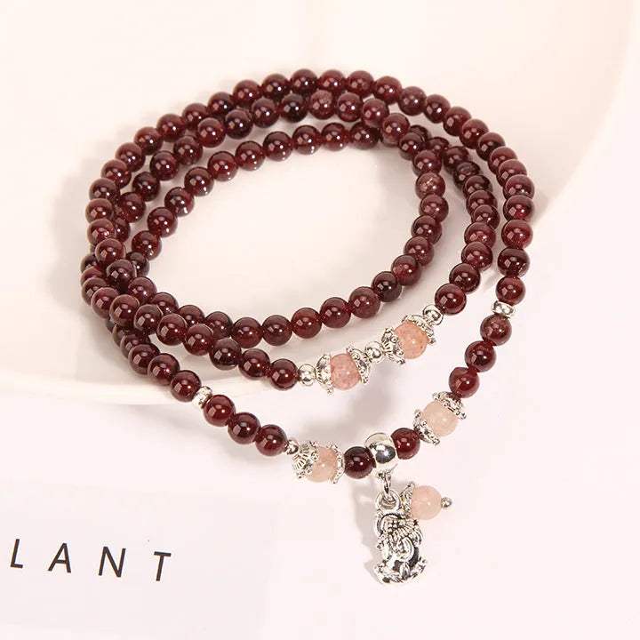 Women's wine red garnet crystal floral bracelet with bohemian design.