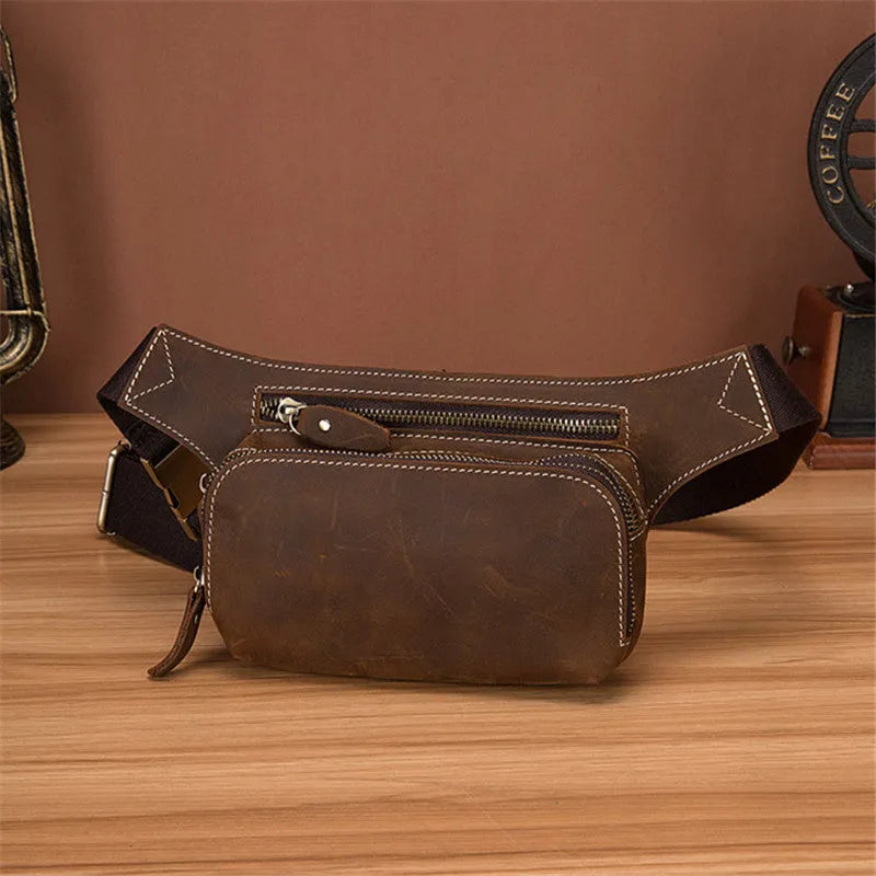 Brown cowhide leather men's waist bag with pull closure, shown with internal mobile phone compartment.